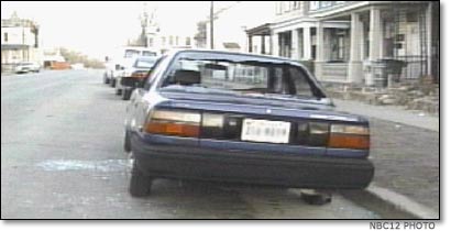 Bullet-riddled car on 24th Street, Richmond, Virginia
